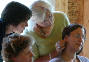 Linda Tellington-Jones using Ear Strokes while participants watch.